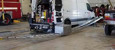 A ladder being tested bearing the weight of a heavy object in a fire department.